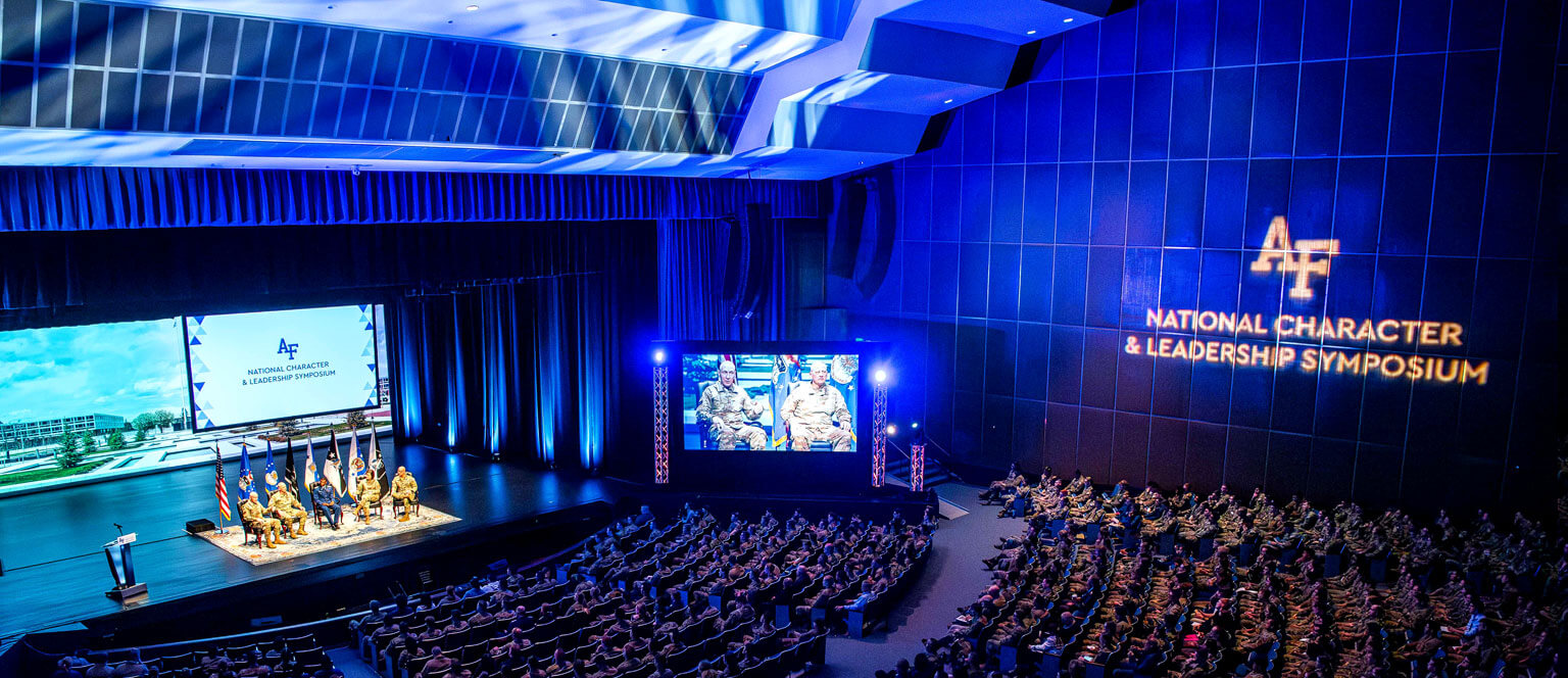 View of stage and audience members during a National Character & Leadership Symposium lecture.